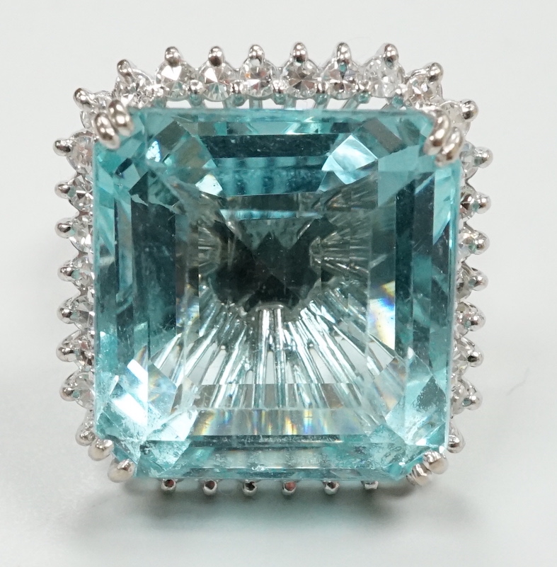 A modern 18ct white metal, simulated aquamarine and diamond chip cluster set dress ring, size P/Q, gross weight 16.3 grams